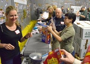Moving food on the conveyor at Second Harvest