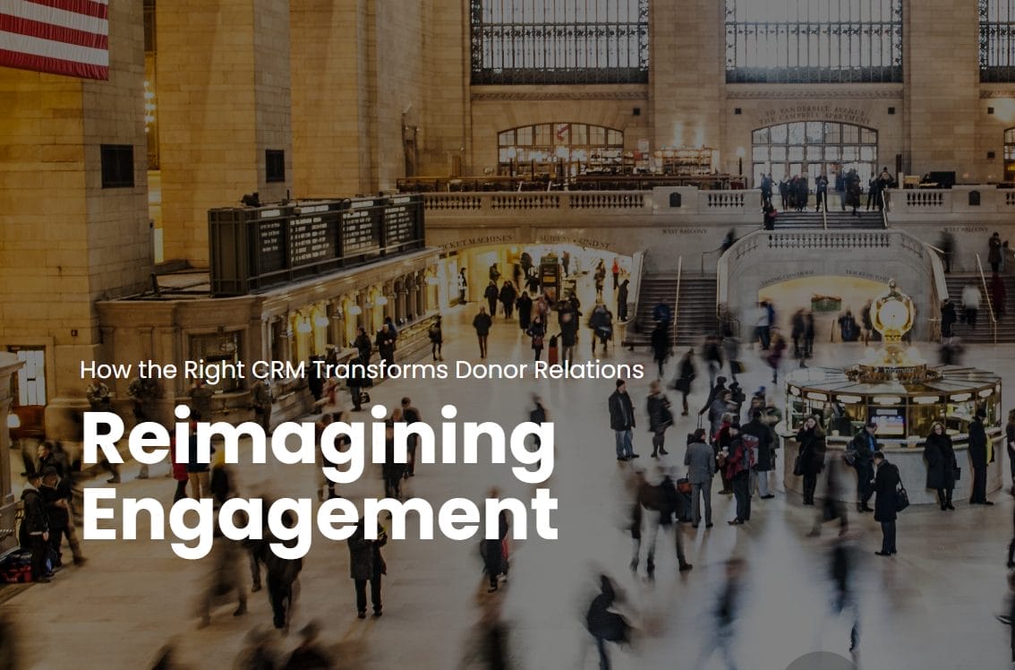 Busy interior of a grand train station with blurred crowds walking. Text over the image reads: How the Right CRM Transforms Donor Relations. Reimagining Engagement.