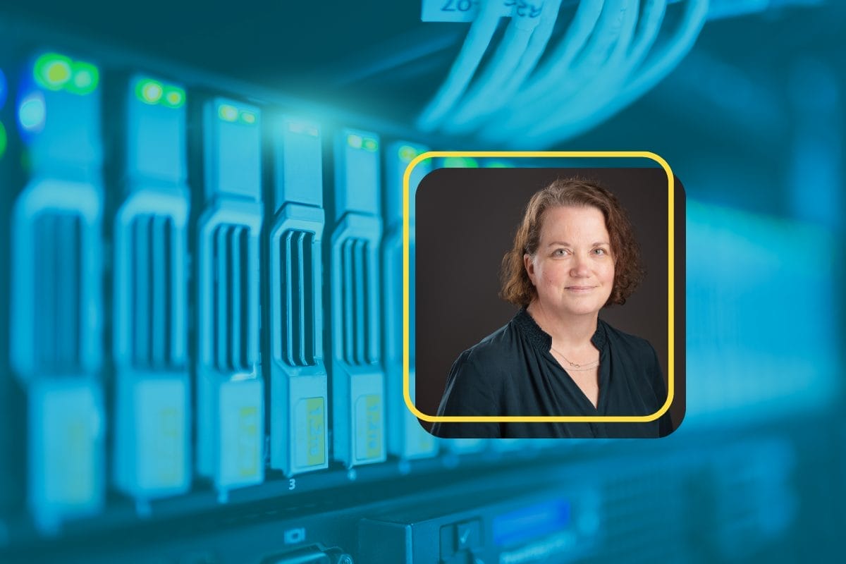A close-up of server racks with glowing lights, overlaid with a bordered portrait of Venta Cantwell, Raisers Edge consultant, who recently joined Heller Consulting—she has short curly brown hair, a dark blouse, a necklace, and a slight smile.