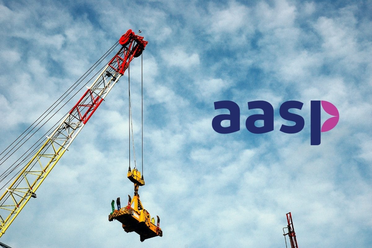 A tall construction crane lifts equipment against a cloudy blue sky. The letters aasp in stylized purple font appear on the right side of the image.